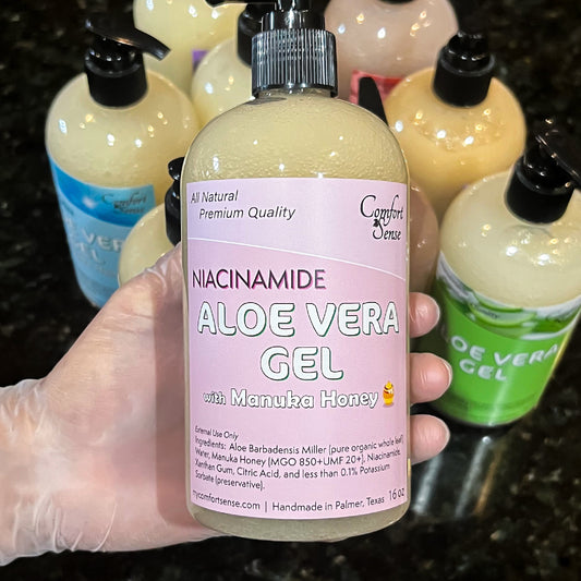 Hand holding a bottle of Aloe Vera Gel with Niacinamide and Manuka Honey, surrounded by other similar bottles.
