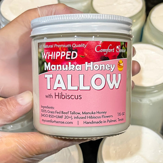 Hand holding a jar of whipped manuka honey tallow with hibiscus, by Comfort Sense.